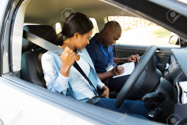 young african girl putting on seatbelt